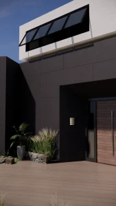 House entrance clad in large charcoal Lapitec Nero Antracite panels, with a wooden door and plants