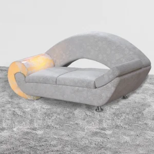Solace Stone Sofa: curved grey sofa with a glowing yellow marble armrest