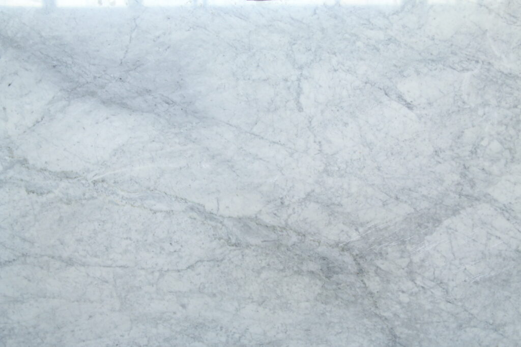 White Carrara marble surface with fine grey veins